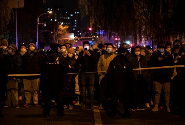 Police keep some protesters behind a cordon during a protest against the Chinese regime's strict zero-COVID measures in Beijing, China, on Nov. 27, 2022. (Kevin Frayer/Getty Images)