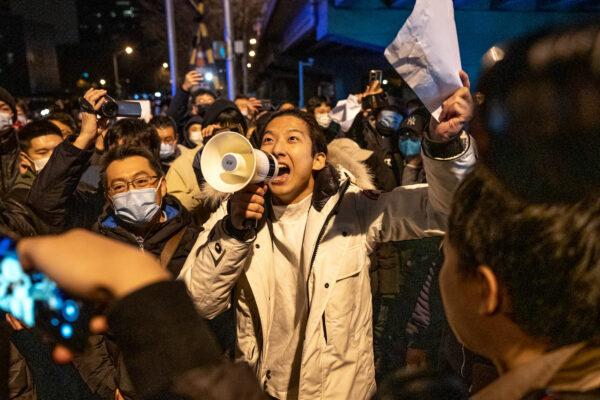 A demonstrator holds a blank sign and chants slogans during a protest against draconian COVID-19 measures in Beijing on Nov. 28, 2022. (Bloomberg via Getty Images)