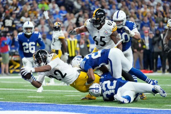 Pittsburgh Steelers' Najee Harris (22) dives in for a touchdown against Indianapolis Colts' Julian Blackmon (32) and Kenny Moore II (23) during the first half of an NFL football game in Indianapolis, on Nov. 28, 2022. (AP Photo/AJ Mast)
