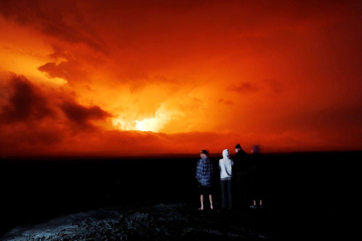 People watch the eruption of Mauna Loa, near Hilo, Hawaii, on Nov. 28, 2022. (Marco Garcia/AP Photo)