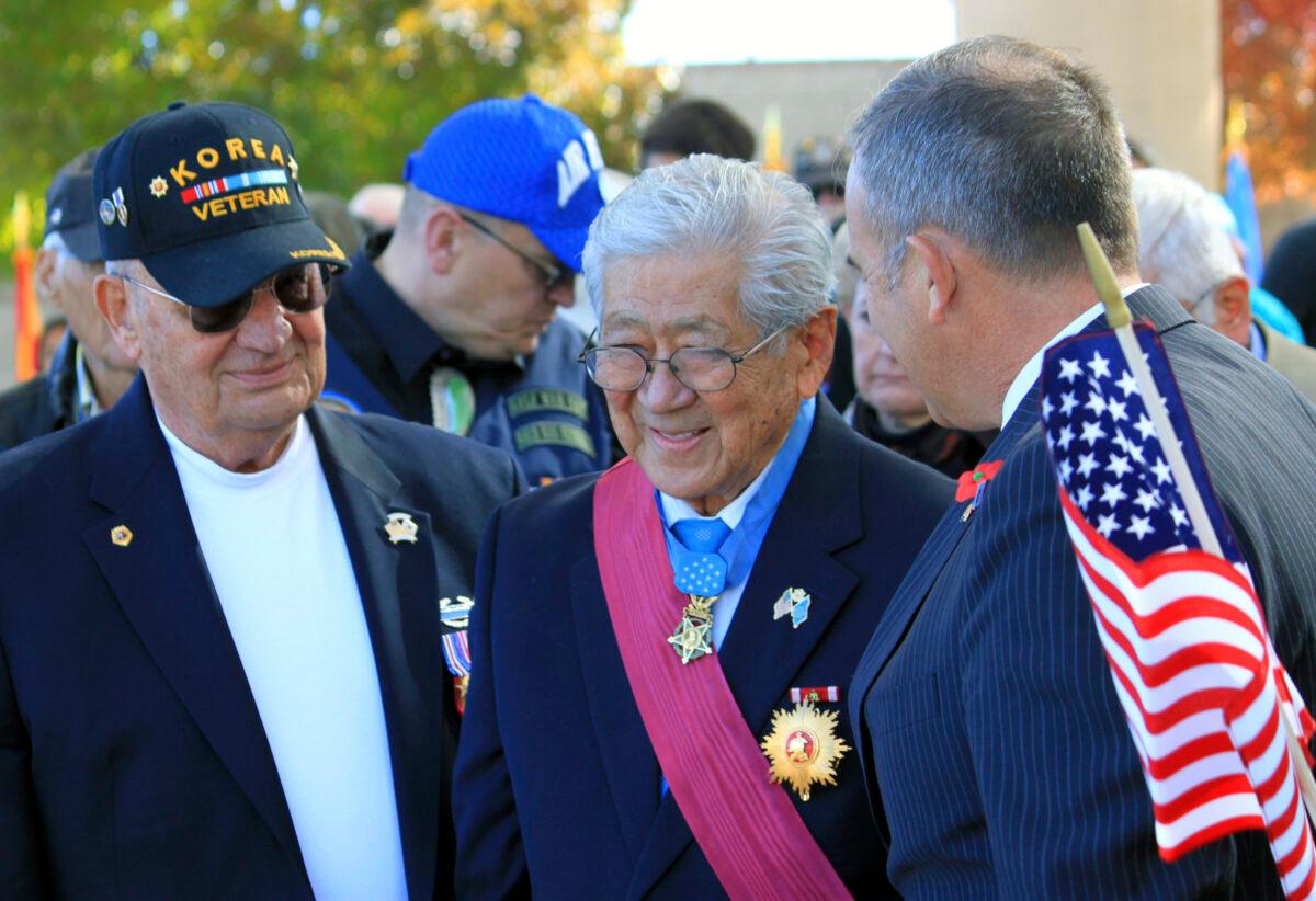 People stand to honor Medal of Honor recipient Hiroshi Miyamura (C) during a Veterans Day ceremony at the New Mexico Veterans Memorial in Albuquerque, N.M., on Nov. 11, 2014. (Susan Montoya Bryan/AP Photo)