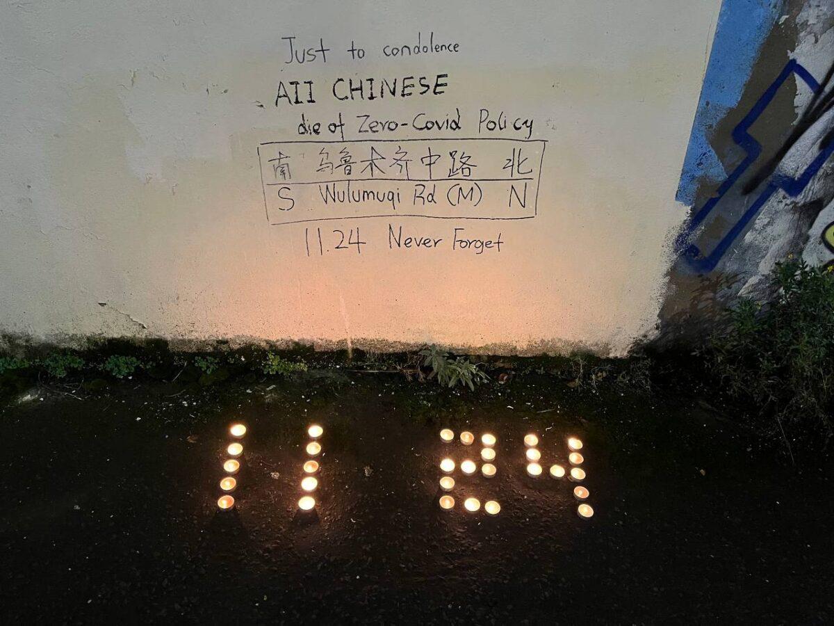 Following the crackdown of a vigil on Shanghai's Middle Wulumuqi Road for victims of an apartment fire that broke out in Wulumuqi, Xinjiang, on Nov. 24, 2022, a sign of Wulumuqi Road and candles are seen in Belfast, Northern Ireland, on Nov. 30, 2022. (Courtesy of Xiaoxi)