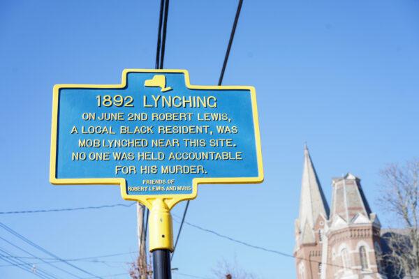 A street marker about the 1892 lynching was erected near the tree from which Robert Lewis was hanged in Port Jervis, N.Y., on Nov. 23, 2022. The tree was torn down not long after the crime to make space for a new church. (Cara Ding/The Epoch Times)