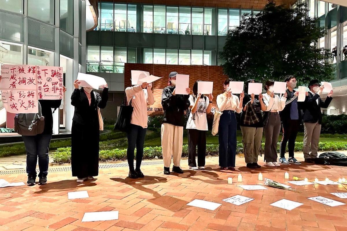 On the evening of Nov. 29, 2022, more than a dozen Chinese students from HKU held up their pleas on campus. (Sung Pi-Lung/The Epoch Times)