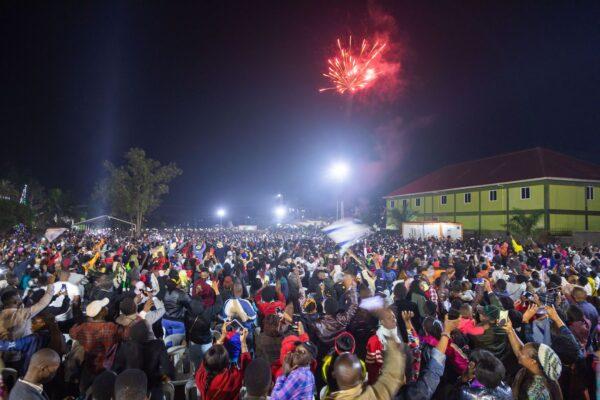 Fireworks light up the sky as people react while they celebrate after counting down to the new year at Miracle Center Cathedral in Kampala, Uganda, on Jan. 1, 2023. (Badru Katumba/AFP via Getty Images)