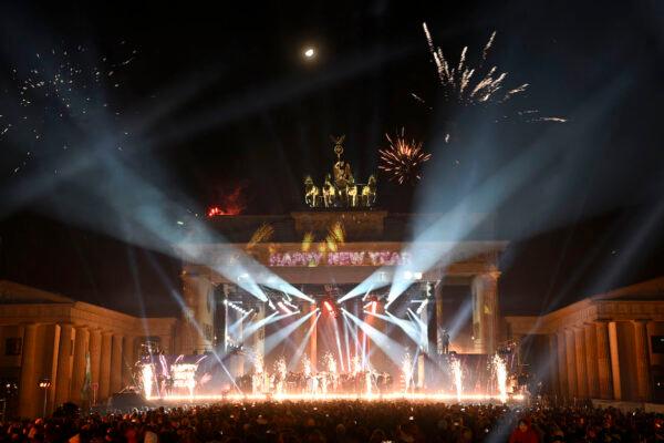 Fireworks explode over Berlin's landmark, the Brandenburg Gate, during a New Year's light and music show before midnight to welcome the year 2023 on Jan. 1, 2023. (Tobias Schwarz/AFP via Getty Images)