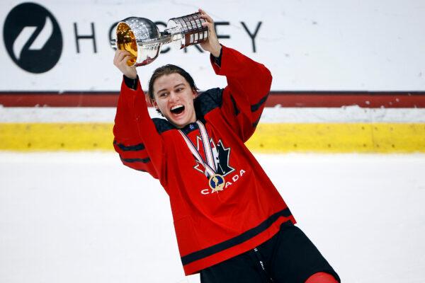 Connor Bedard of Canada celebrates with the championship trophy after defeating Russia 5-3 in the 2021 IIHF Ice Hockey U18 World Championship Gold Medal Game at Comerica Center in Frisco, Texas, on May 6, 2021 . (Tom Pennington/Getty Images)