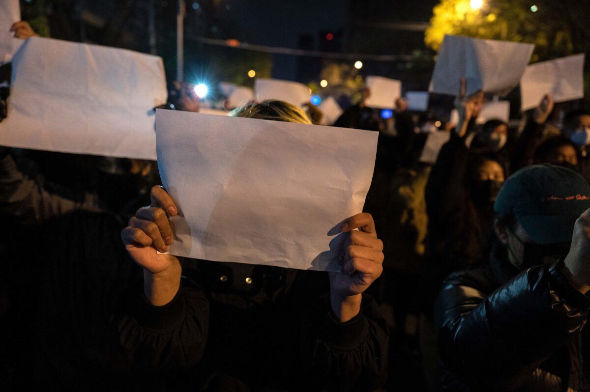 Protesters hold up a white piece of paper against censorship as they march during a protest against Chinas strict zero-COVID measures in Beijing on Nov. 27, 2022. (Kevin Frayer/Getty Images)