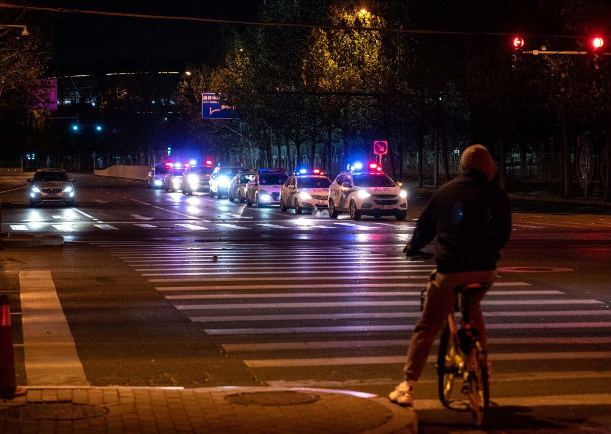 Police cars wait at an intersection as they patrol in an area where there were rumors of a planned protest against the country's zero-COVID measures in Beijing on Nov. 29, 2022. (Kevin Frayer/Getty Images)