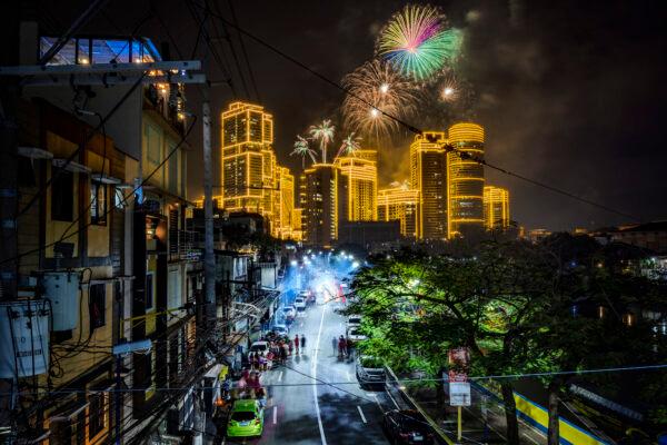Fireworks explode over buildings during New Year's celebrations in Makati, Metro Manila, Philippines, on Jan. 1, 2023. (Ezra Acayan/Getty Images)
