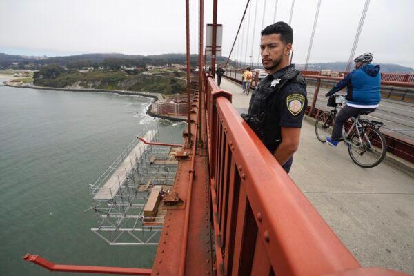 Patrol officer Nicolas Serrano looks out at a suicide barrier under construction below the Golden Gate Bridge in San Francisco on Aug. 3, 2021. (Eric Risberg/AP Photo)