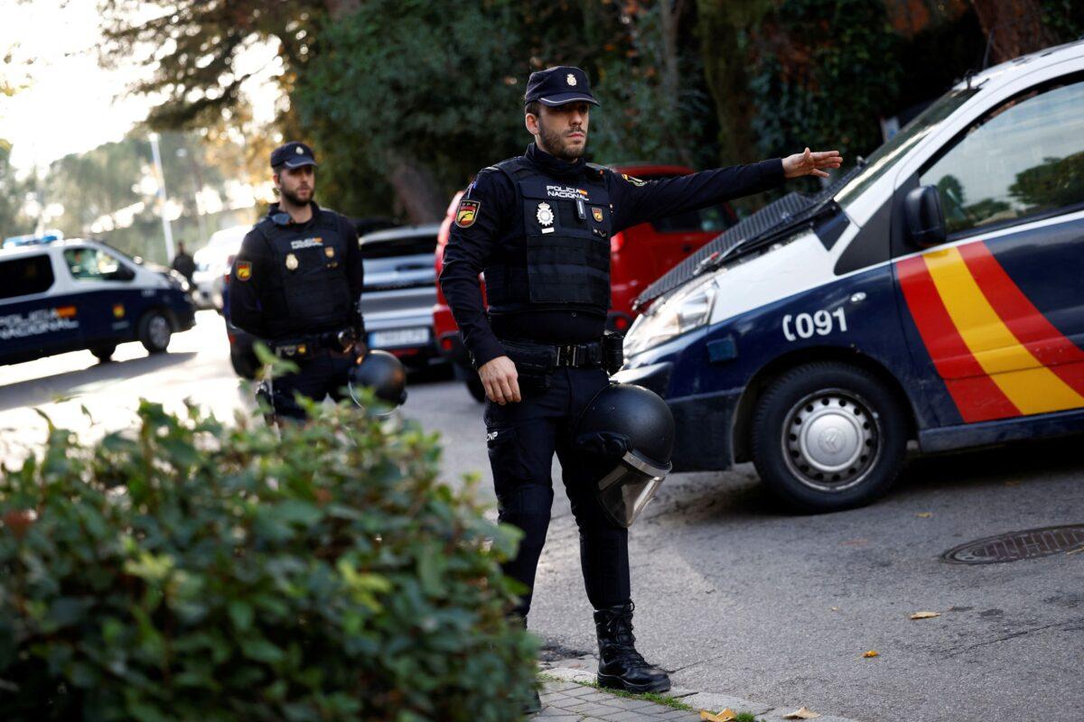 A member of police gestures outside of Ukrainian embassy after, Spanish police said, blast at embassy building injured one employee while handling a letter, in Madrid on Nov. 30, 2022. (Juan Medina/Reuters)