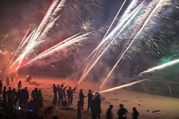 People celebrate the new year with fireworks on a beach in Houhai, in Sanya in China's southern Hainan province on Jan. 1, 2023. (Hector Rectamal/AFP via Getty Images)