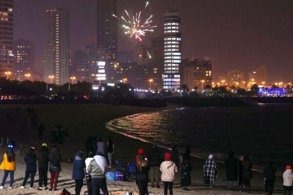 People watch fireworks as they celebrate the New Year in Kuwait City early on Jan. 1, 2023. (Yasser al-Zayyat/AFP via Getty Images)
