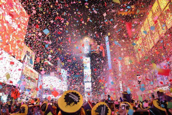 Onlookers watch as confetti fills the air to mark the beginning of the new year, in Times Square, New York City, on Jan. 1, 2023. (Yuki Iwamura/AFP via Getty Images)