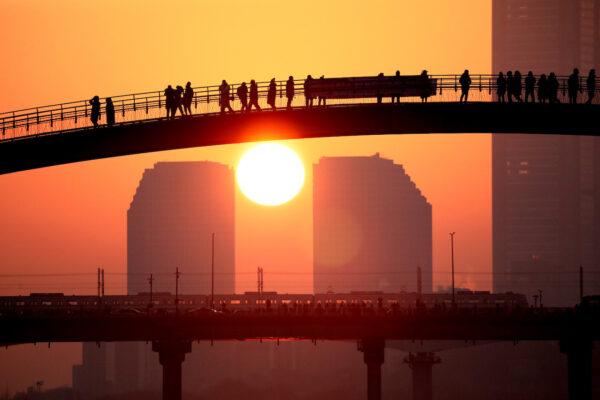 Members of the public look at the first sunrise of the year during New Year's celebrations at a park in Seoul, South Korea, on Jan. 1, 2023. (Chung Sung-Jun/Getty Images)