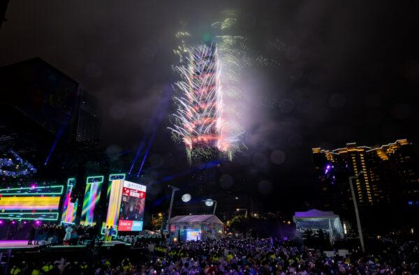 People celebrate as fireworks light up the skyline from the Taipei 101 building during New Year's celebrations in Taipei, Taiwan, on Jan. 1, 2023. (Gene Wang/Getty Images)