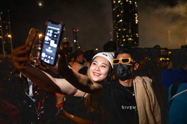 People take a selfie during a fireworks display on New Years Eve from the King Taksin Bridge in Bangkok, Thailand, on Jan. 1, 2023.(Lauren DeCicca/Getty Images)