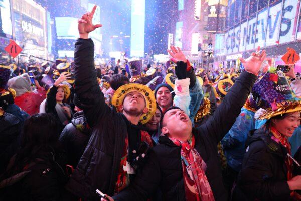 Onlookers cheer as confetti fills the air to mark the beginning of the new year, in Times Square, New York City, on Jan. 1, 2023. (Yuki Iwamura/AFP via Getty Images)