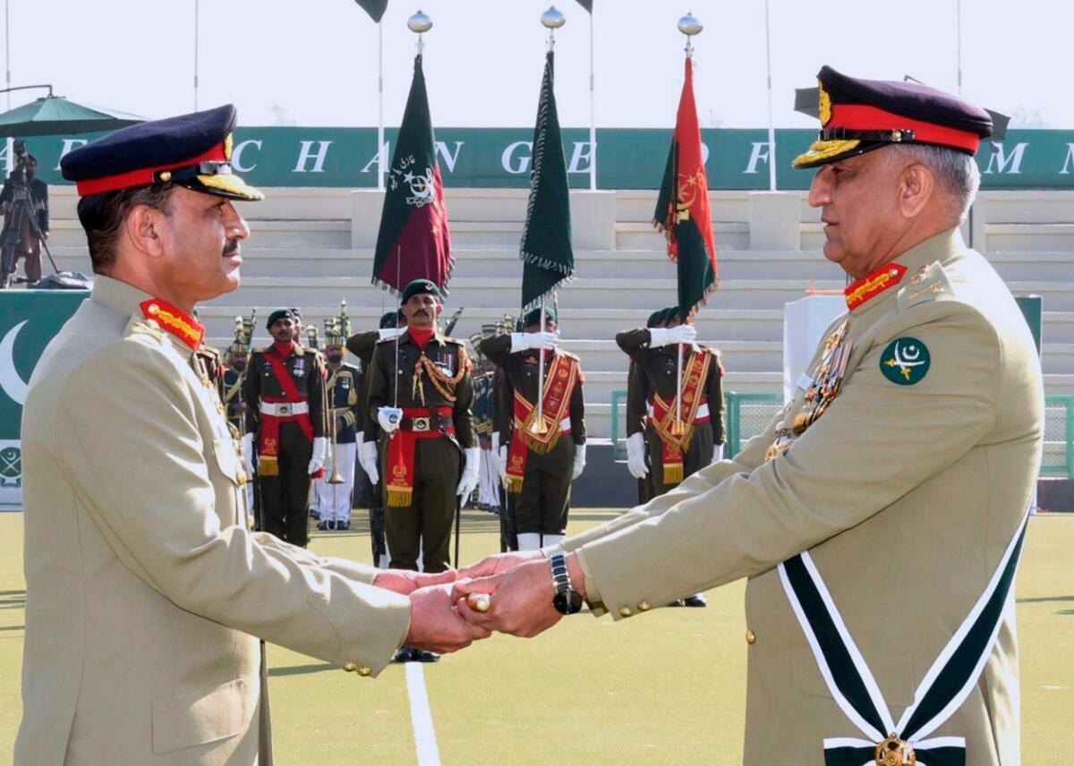 Pakistan's outgoing Army Chief Gen. Qamar Javed Bajwa (R) hands over a ceremonial baton to his successor Gen. Asim Munir during the Change of Command ceremony n Rawalpindi, Pakistan, on Nov. 29, 2022. (Inter Services Public Relations via AP)