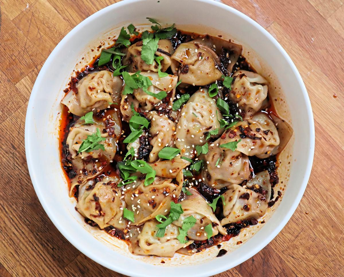 Bathed in fiery sauce enlivened with garlic and Sichuan peppercorn, these pork-stuffed wontons are a spicy bowl of perfection. (Gretchen McKay/Pittsburgh Post-Gazette/TNS)