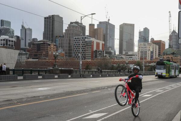 A cyclist rides along an empty St Kilda Road in Melbourne, Australia, on June 5, 2021. (Asanka Ratnayake/Getty Images)