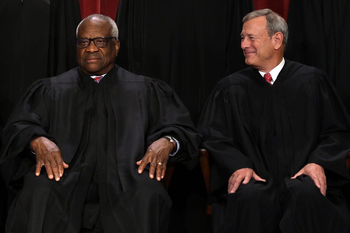 Chief Justice John Roberts, right, with Justice Clarence Thomas while sitting for the high court's official portrait in Washington on Oct. 7, 2022. (Alex Wong/Getty Images)