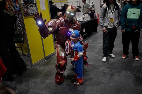 A little boy dressed as Captain America has his photograph taken with Iron Man as they attend the London Super Comic Convention in the Excel Centre in London, England, on March 15, 2014. (Mary Turner/Getty Images)