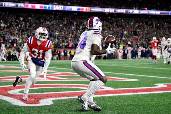 Wide receiver Stefon Diggs (14) of the Buffalo Bills catches a first half touchdown pass in front of cornerback Jonathan Jones (31) of the New England Patriots at Gillette Stadium in Foxborough, Mass., on Dec. 1, 2022. (Billie Weiss/Getty Images)
