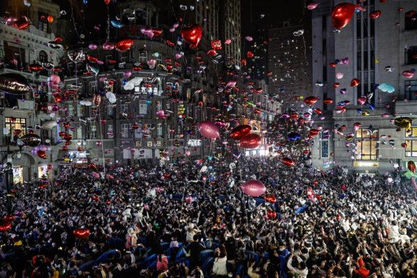 Revelers release balloons to celebrate the New Year on pedestrian street Jianghan Road in Wuhan, China, on Dec. 31, 2022. (Getty Images)