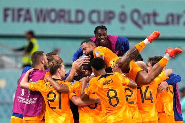 Players of the Netherlands celebrate their side's second goal by Daley Blind during the World Cup round of 16 soccer match between the Netherlands and the United States, at the Khalifa International Stadium in Doha, Qatar, on Dec. 3, 2022. (Martin Meissner/AP Photo)