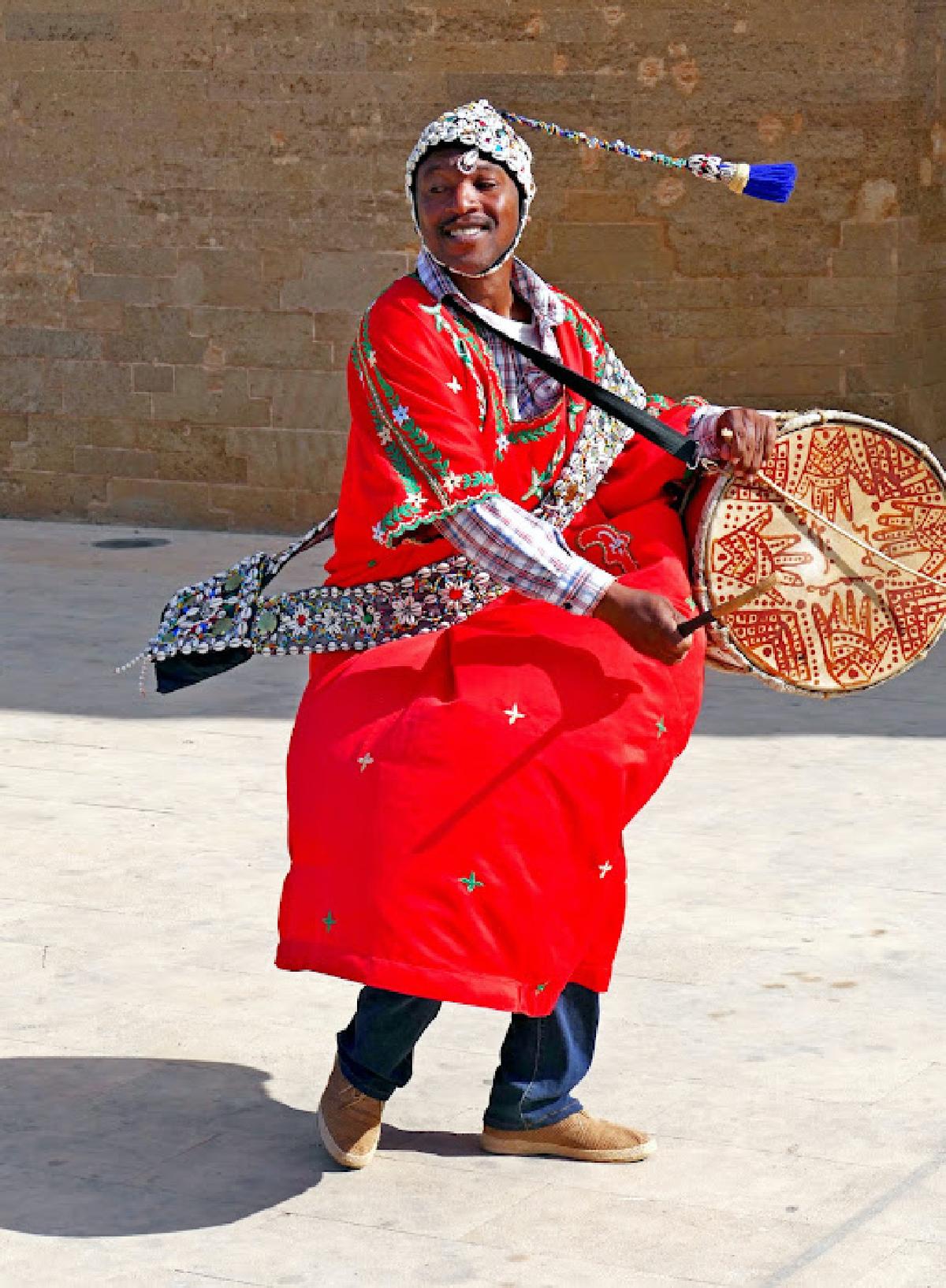 A gnawa musician plays and sings outside the Kasbah des Oudaias in Rabat, Morocco. (Photo courtesy of Phil Allen.)