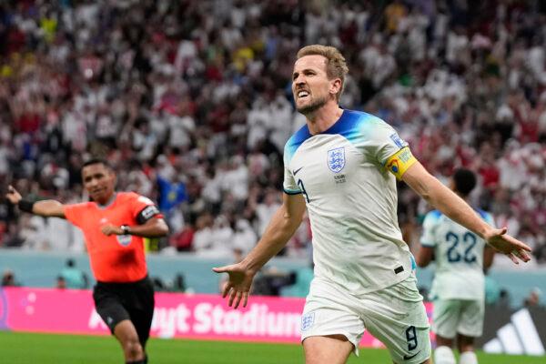 England's Harry Kane celebrates scoring his side's second goal during the World Cup round of 16 soccer match between England and Senegal, at the Al Bayt Stadium in Al Khor, Qatar, on Dec. 4, 2022. (Frank Augstein/AP Photo)