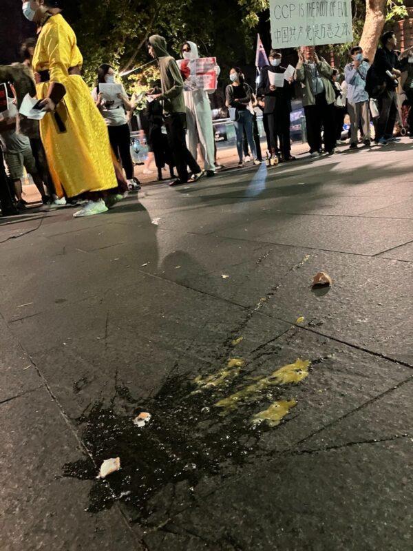 People threw eggs and one protester was hit on the head by a rock as unknown individuals attacked a peaceful rally in support of China's mass protests in Sydney, Australia, on Dec. 3, 2022. (Melanie Sun/The Epoch Times)