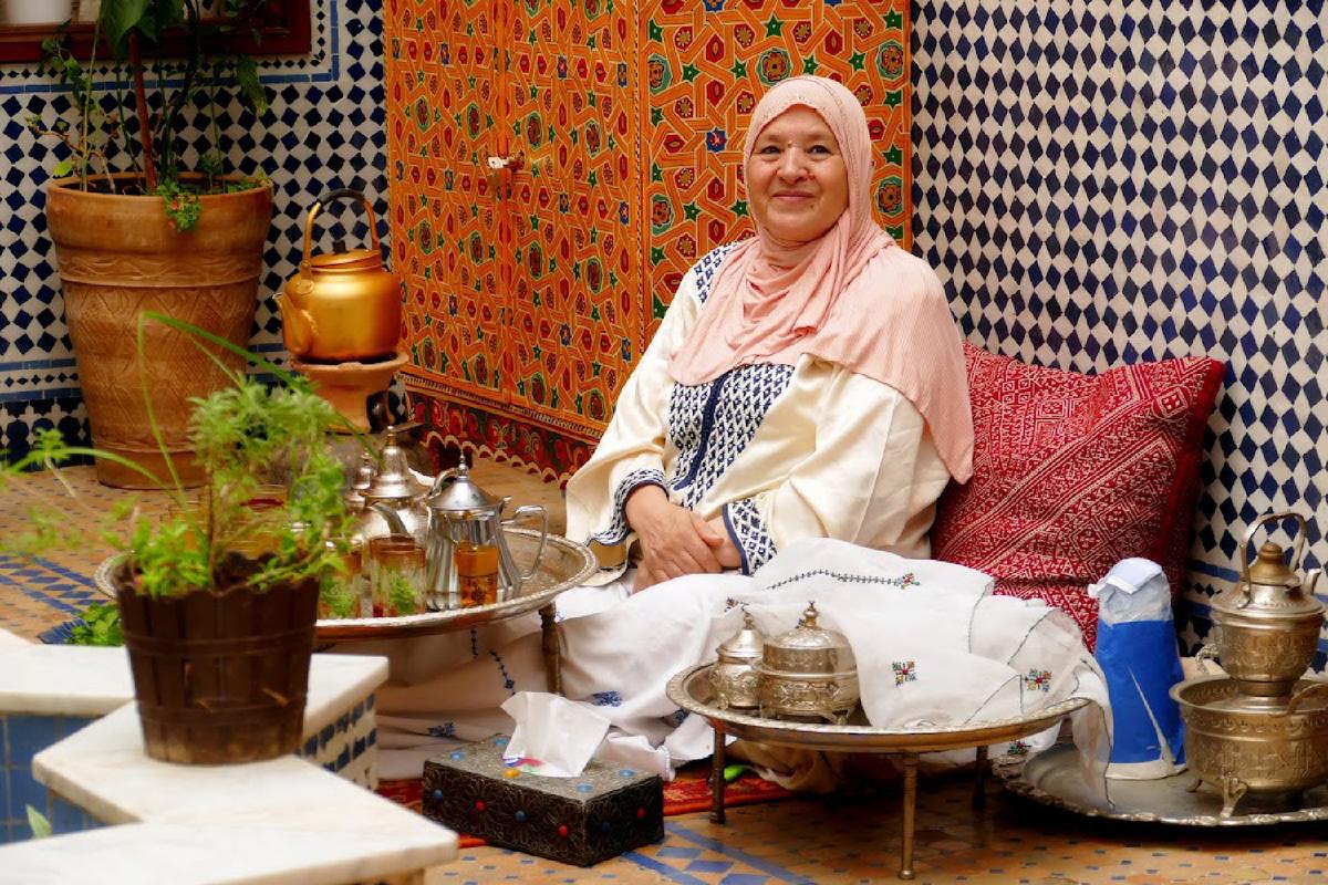 A woman serves mint tea to guests at her home in Fes, Morocco. (Courtesy of Phil Allen)
