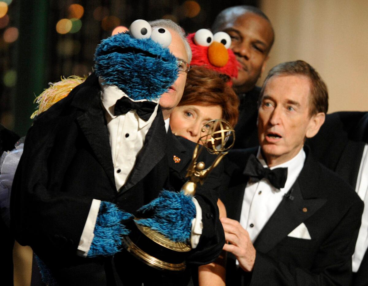 Bob McGrath (R) looks at the Cookie Monster as they accept the Lifetime Achievement Award for '"Sesame Street" at the Daytime Emmy Awards in Los Angeles on Aug. 30, 2009. (Chris Pizzello/AP Photo)