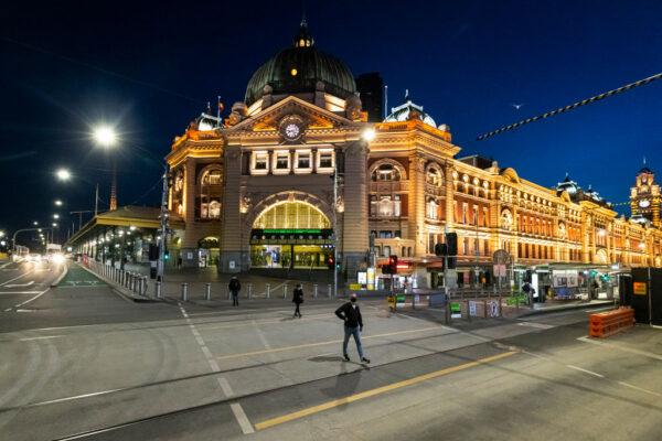 People walk across Flinders Street in Melbourne, Australia, on Oct. 20, 2021. (Daniel Pockett/Getty Images)