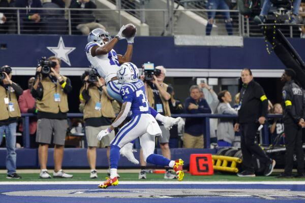 Dallas Cowboys' Michael Gallup (13) makes a touchdown catch against Indianapolis Colts' Isaiah Rodgers (34) during the second half of an NFL football game in Arlington, Texas, on Dec. 4, 2022. (Michael Ainsworth/AP Photo)