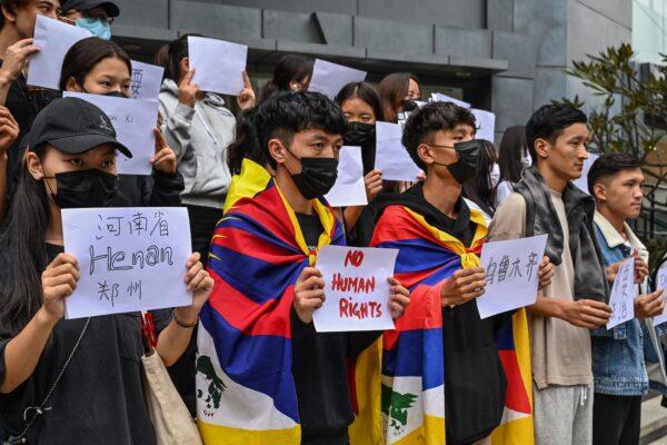 Young Tibetans stage a silent protest as part of the ongoing White Paper revolution against the Zero-COVID policy and severe censorship of the Chinese communist regime, in Bengaluru, India, on December 1, 2022. (MANJUNATH KIRAN/AFP via Getty Images)