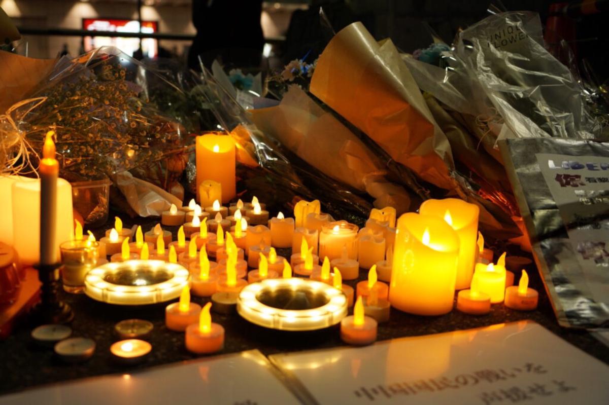 A gathering on Nov. 30 at the public square in front of Tokyo’s Shinjuku Station, mourning victims of the deadly fire in Urumqi, Xinjiang, China. (Ellen Wan/The Epoch Times)