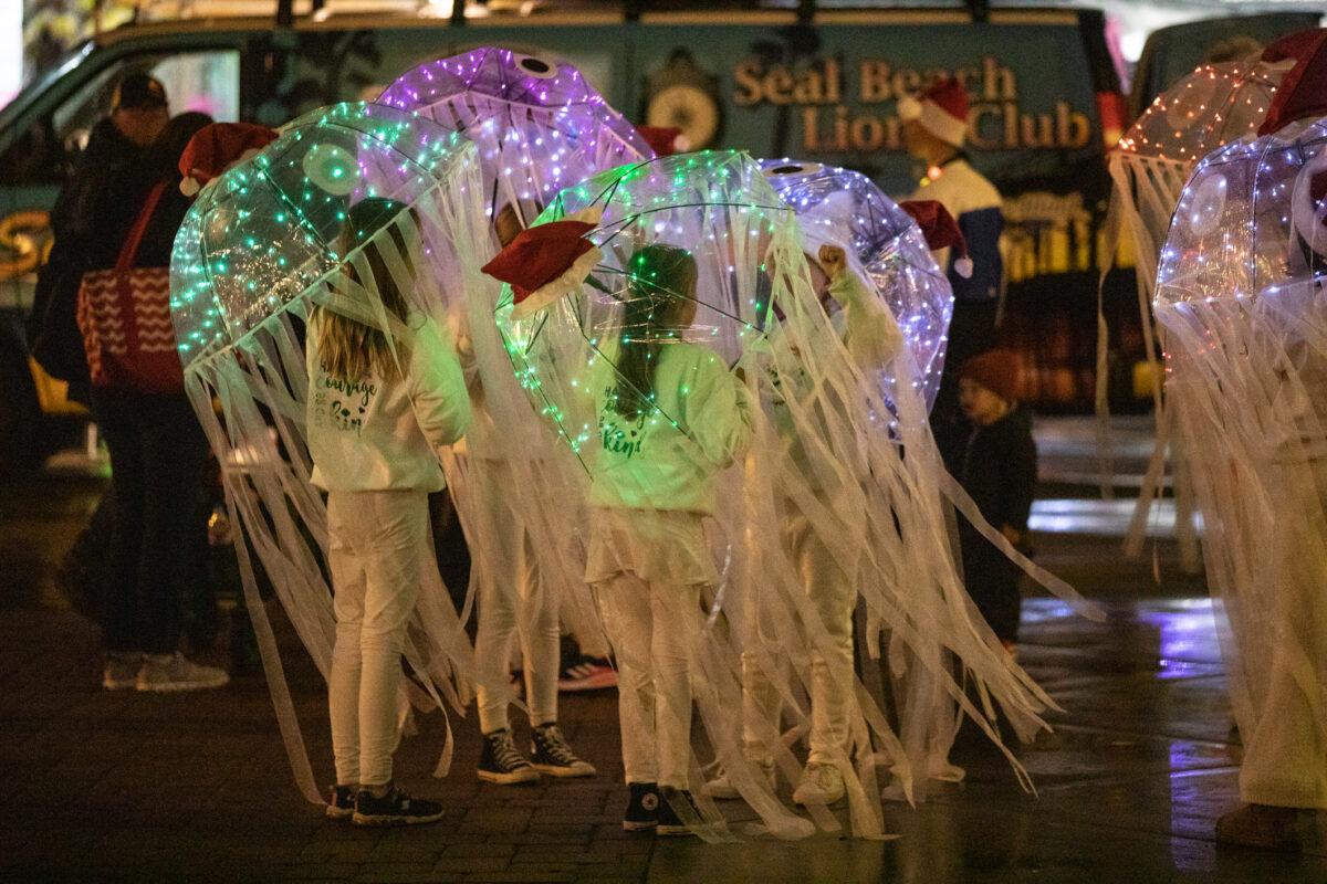 People walk through the Seal Beach Christmas Parade in Seal Beach, Calif., on Dec. 2, 2022. (John Fredricks/The Epoch Times)