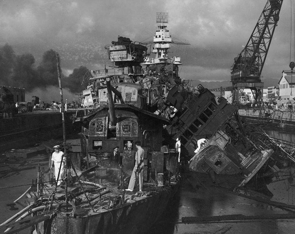 Sailors walk amid the wreckage of the U.S. destroyers USS Cassin and USS Downes after the Japanese attack on Pearl Harbor, Hawaii, on Dec. 7, 1941. The battleship USS Pennsylvania is visible in the background. (Hulton Archive/Getty Images)