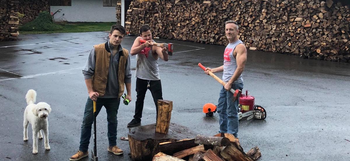 Henry (L), Harrison (C), and Shane McDaniel out chopping wood at their home in Seattle, Washington. (Courtesy of Shane McDaniel)