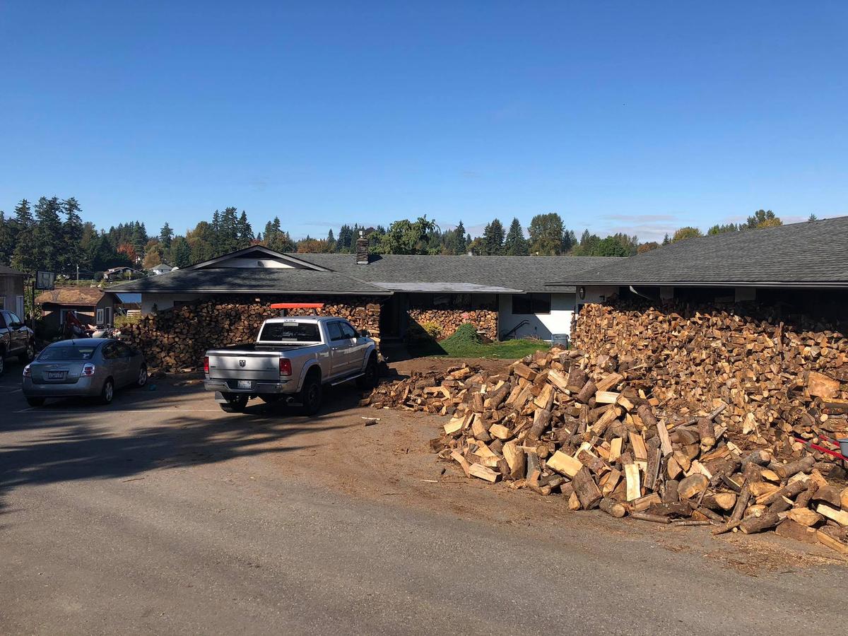 The split wood is stored around the house until delivery. (Courtesy of Shane McDaniel)