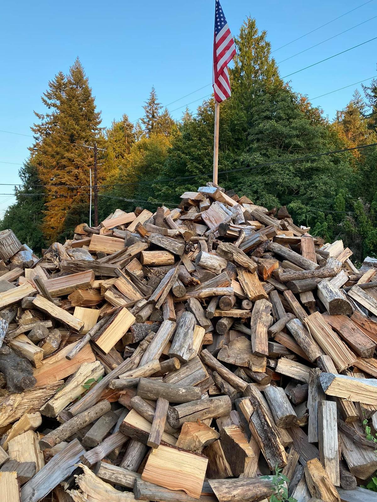 The annual pile of split wood, with an American flag on top, has become a popular place to take selfies. (Courtesy of Shane McDaniel)