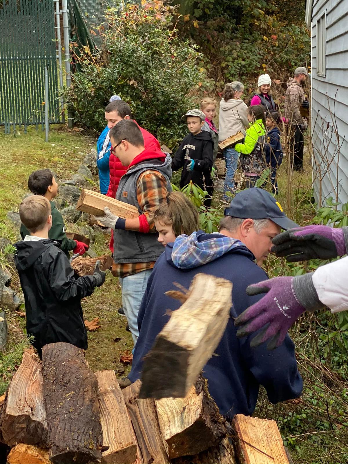 Volunteers help stack the firewood. (Courtesy of Shane McDaniel)