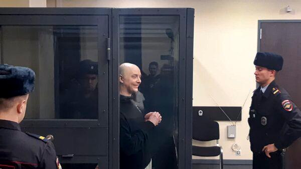 Ivan Safronov, an adviser to the director of Russia's state space corporation is seen on a TV screen, as he appears in a video link provided by the Russian Federal Penitentiary Service in a courtroom of the First Cassation Court of General Jurisdiction in Moscow on Dec. 7, 2022. (Sergei Fedotov/AP Photo)