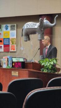  While speaking about vaccine injuries to the Orange County Commission on Nov. 15, 2022, Justin Harvey, of We Are Change Orlando, displays a prop indicating the topic is often avoided in conversation, making it like the proverbial "elephant in the room," he says. (Courtesy of Lori Bontell)