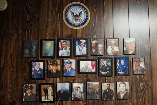 Pictures of family members and close friends in military service on the wall of Ricardo Nieves's office in Monticello, New York, on Dec. 6, 2022. (Cara Ding/The Epoch Times)