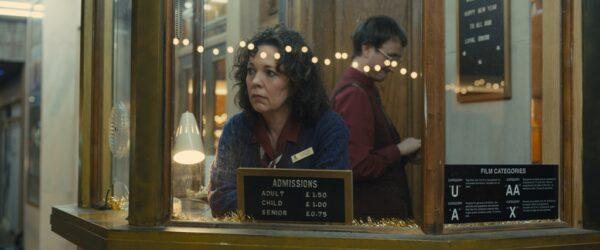 Hilary (Olivia Colman) and Neil (Tom Brooke) at the movie theater, in "Empire of Light." (Searchlight Pictures)